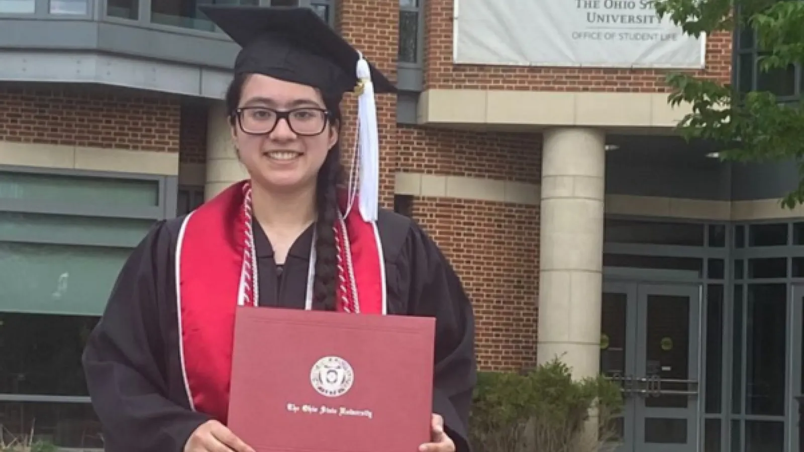 Florencia Ontiveros with diploma after graduation ceremony